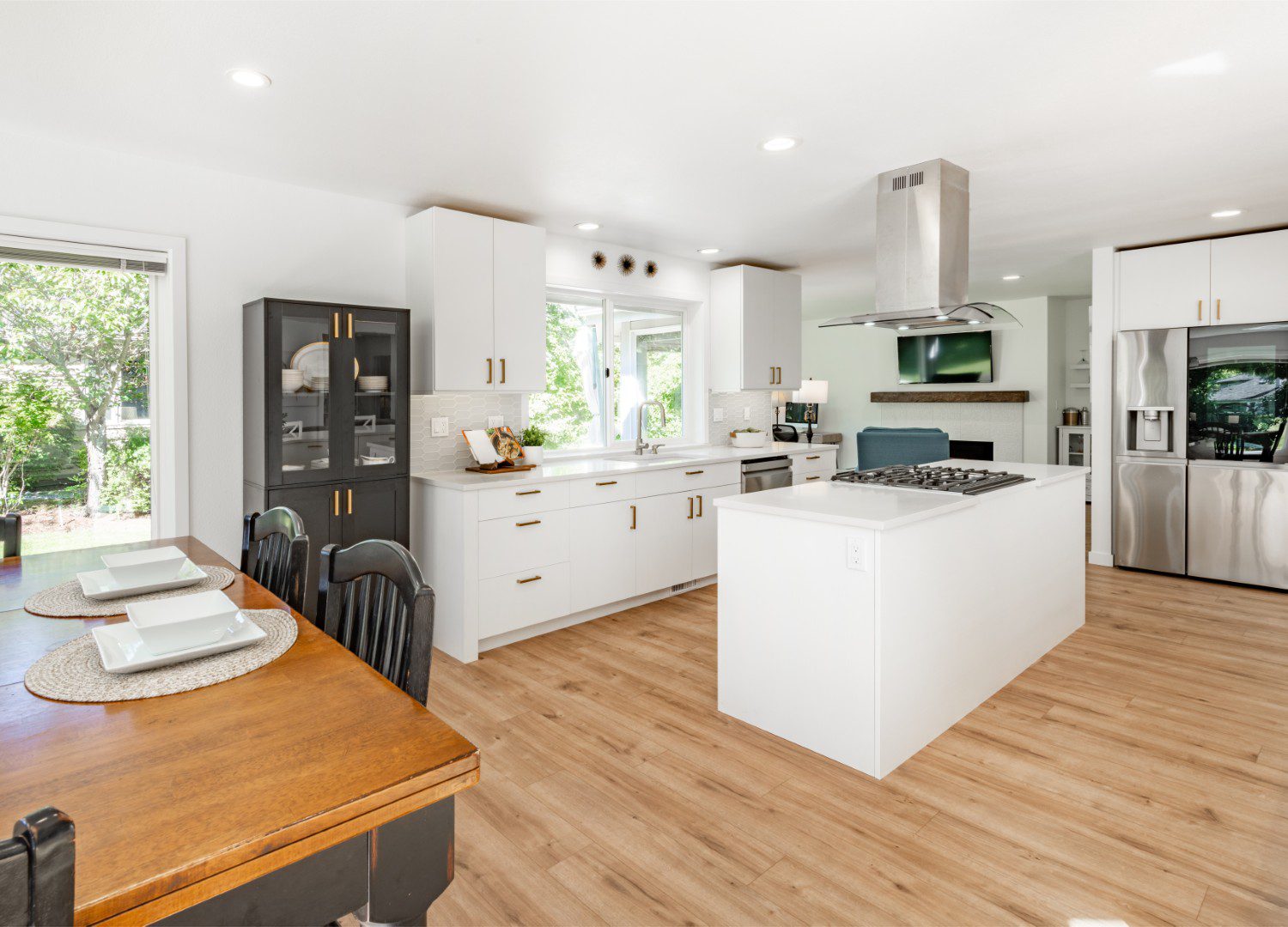 Modern kitchen with island and dining area.