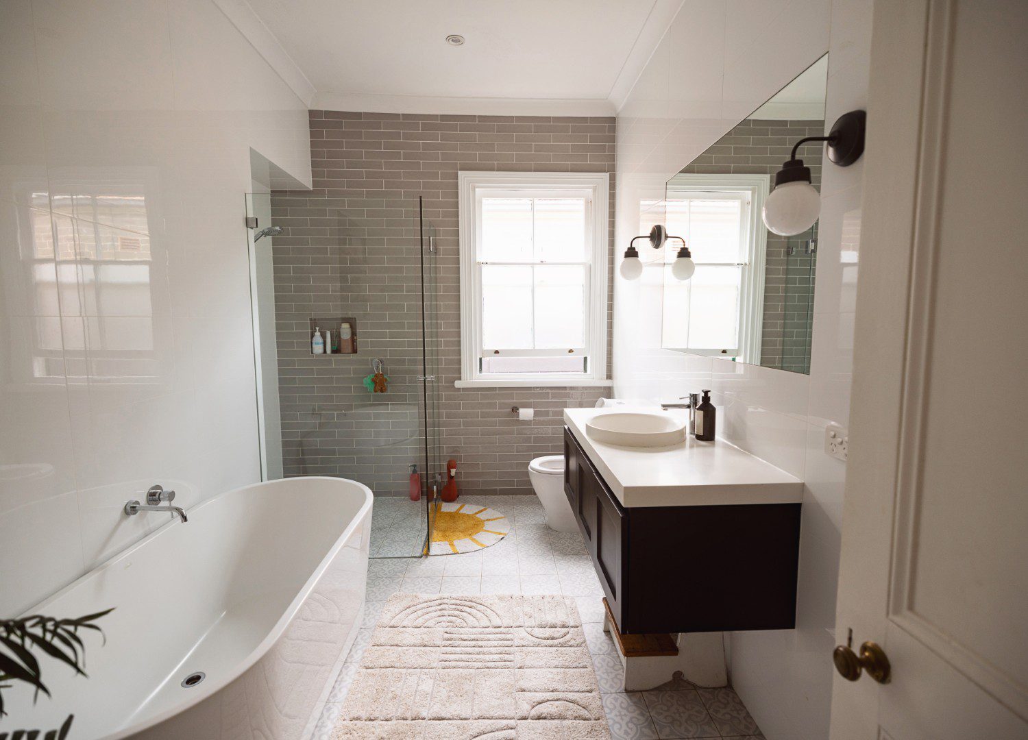 Modern bathroom with bathtub and shower area.