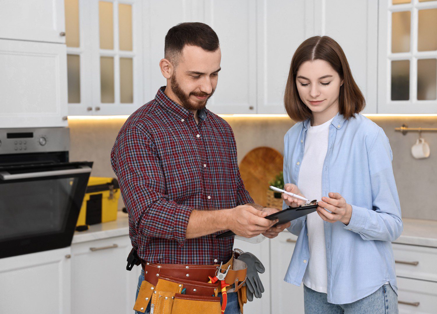 Man and woman discussing in kitchen.